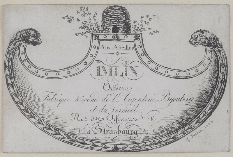 Etiquette de firme d'orfèvre ; Imlin orfèvre (Orfèvre fabrique & vend de l'argenterie bijouterie et du Vermeil, Rue des Orfèvre n°16, à Strasbourg) ; Aux abeilles (Orfèvre fabrique & vend de l'argenterie bijouterie et du Vermeil, Rue des Orfèvre n°16, à Strasbourg)