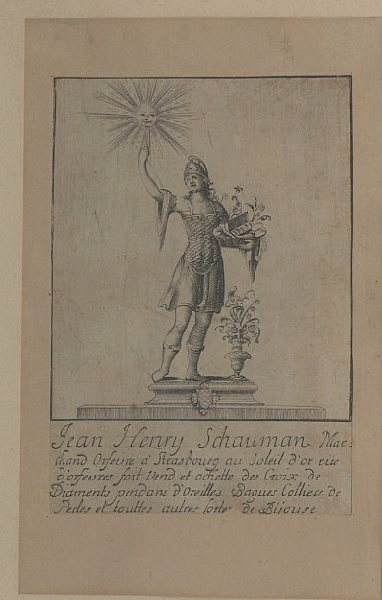 Etiquette de firme d'orfèvre ; Jean-Henry Schauman (Marchand orfèvre à Strasbourg au Soleil d'or rue d'Orfèvres fait, vend et achette des croix de diaments, pendans d'oreilles, bagues colliers der perles et touttes autres sorte de bijoux)