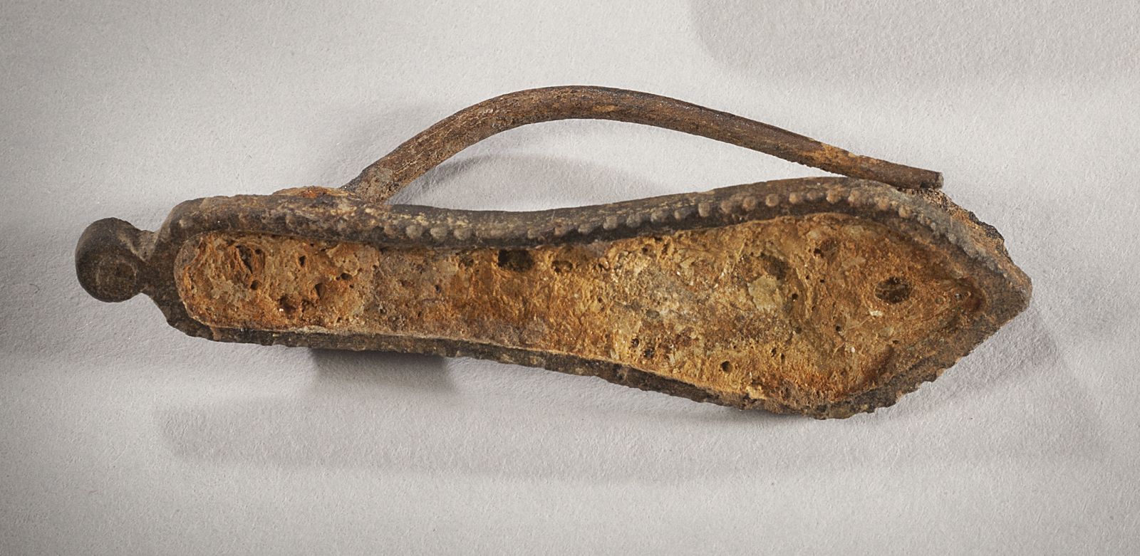 Fibule skeuomorphe en forme de semelle émaillée