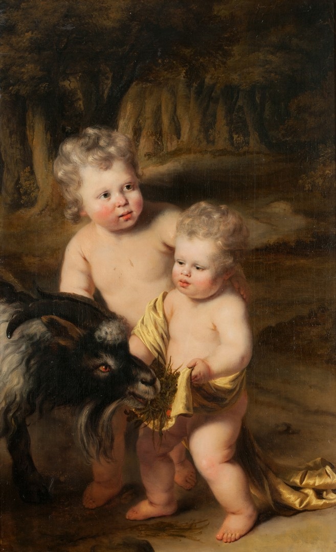Enfants donnant à manger à un bouc