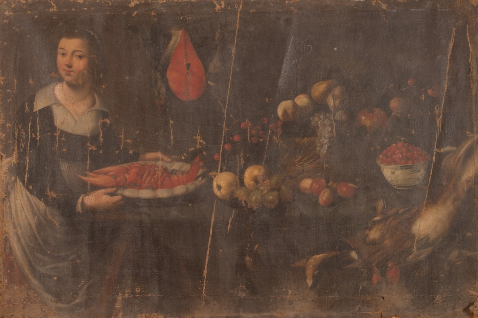 Table de cuisine chargée de victuailles avec cuisinière portant un homard