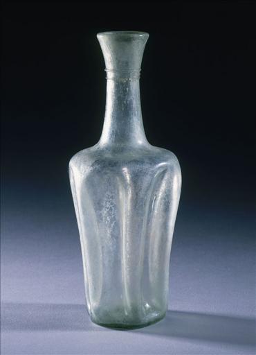 Bouteille à dépressions en verre de couleur ambrée