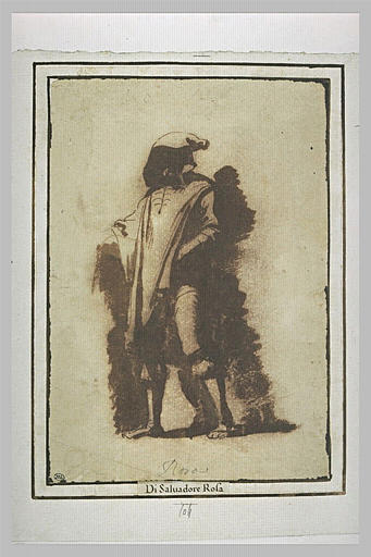 Homme debout, le visage dans l'ombre d'un large capuchon