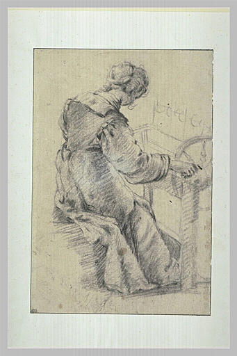 Femme assise, vue de dos, occupée à dévider de la laine