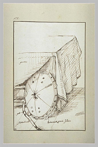 Bouclier appuyé contre une table recouverte d'un tapis