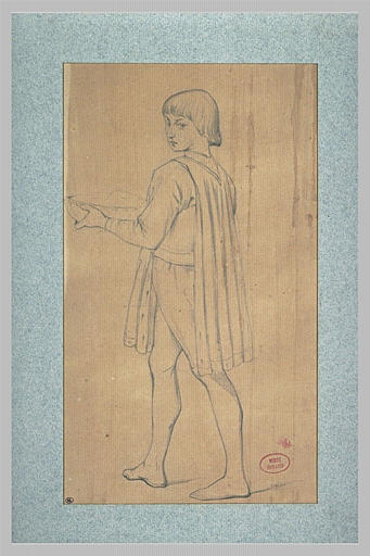 Jeune garçon en costume médiéval portant un plat