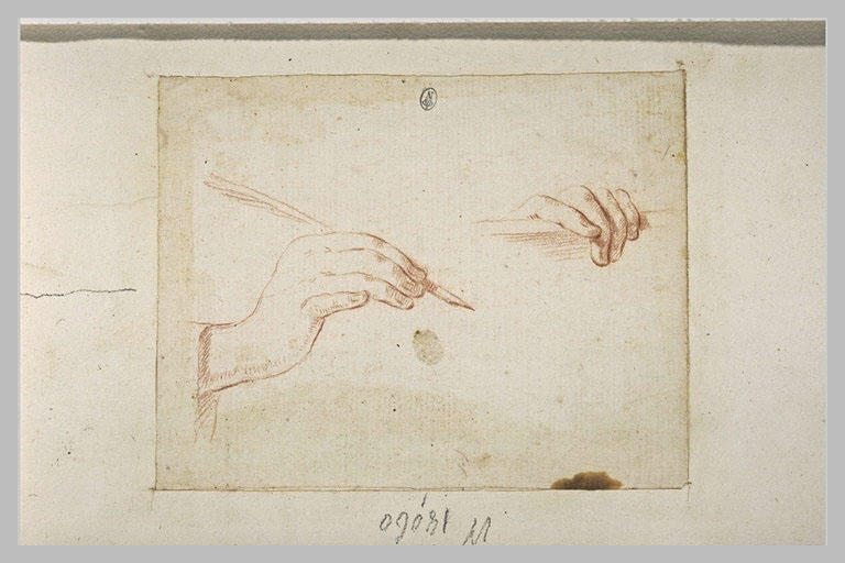 Deux mains dont une tient une plume