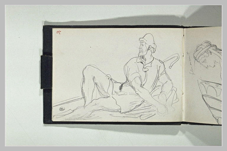 Un berger assis à terre, tourné vers la gauche