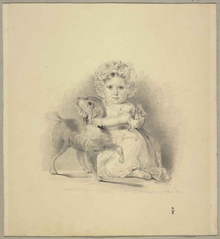 Enfant assis par terre tenant un chien