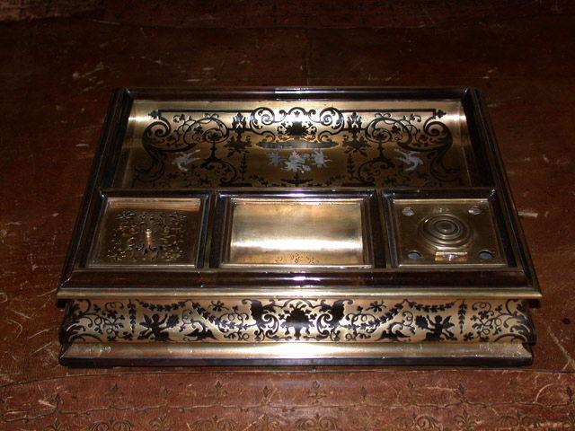 Ecritoire en marqueterie Boulle avec motif d'angelots portant en chaise un personnage et flanqués de 2 griffons