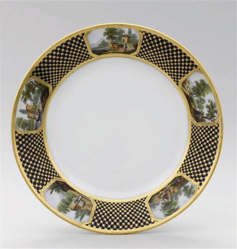 Assiette à dessert en porcelaine de Paris, marquées Feuillet au revers, marli à décor de résille dorée fond bleu orné de 5 cartouches topographiques