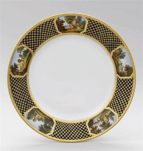 Assiette à dessert en porcelaine de Paris, marquées Feuillet au revers, marli à décor de résille dorée fond bleu orné de 5 cartouches topographiques