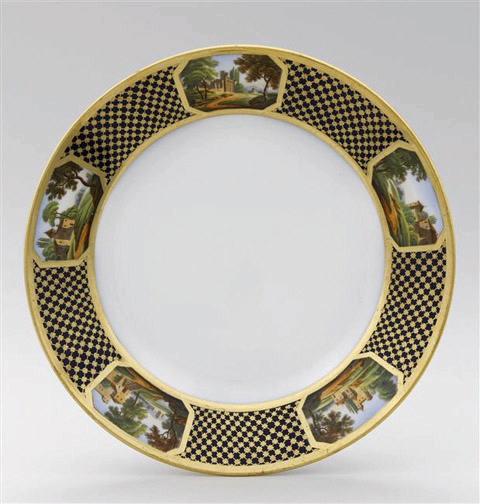 Assiette à dessert en porcelaine de Paris, marquées Feuillet au revers, marli à décor de résille dorée fond bleu orné de 5 cartouches topographiques