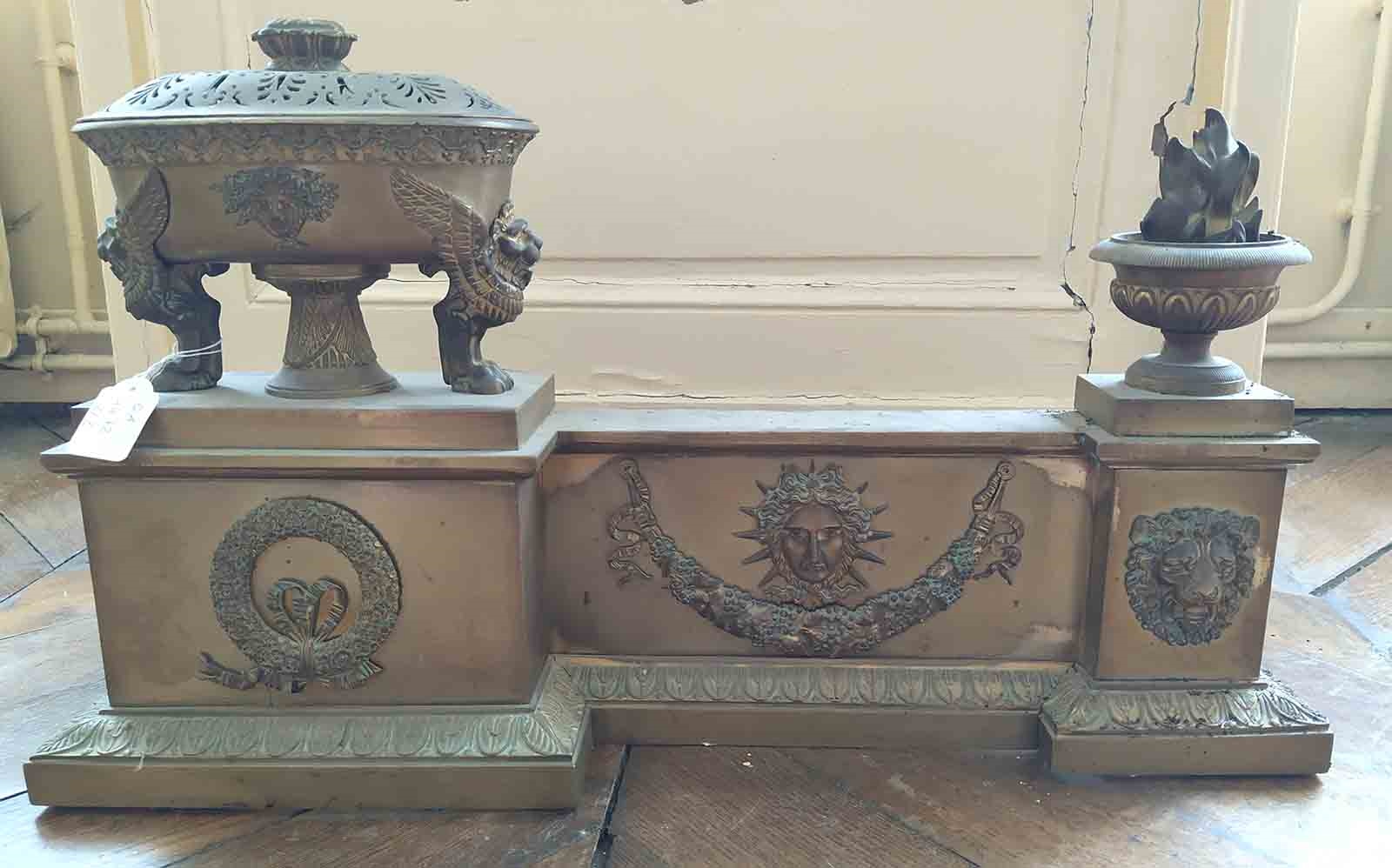 Galerie de cuivre de Style empire en deux parties figurant une cassolettte avec son couvercle, un pot à feu, une tête de lion et une guirlande