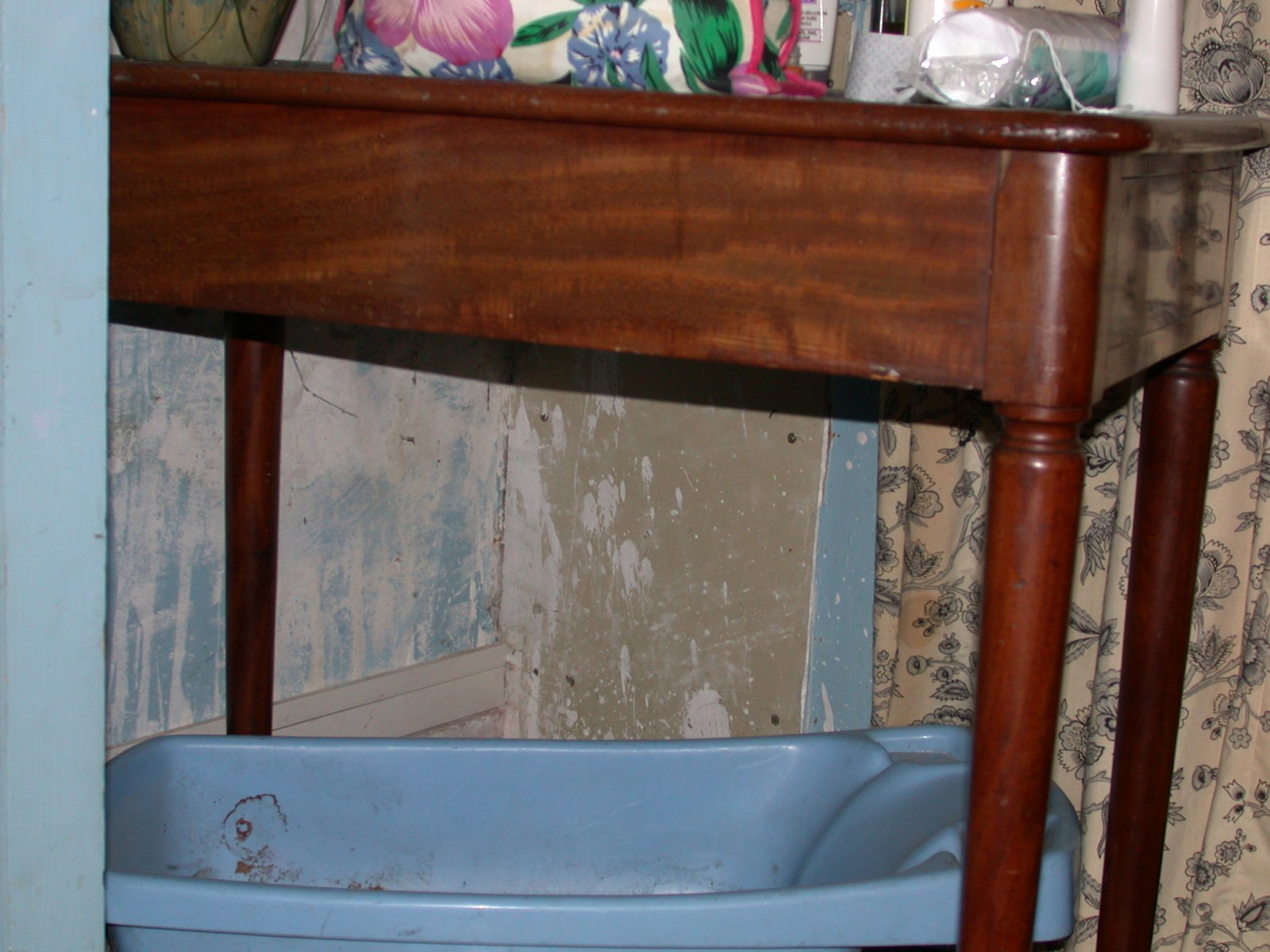 Table rectangulaire en acajou pieds à roulettes, un tiroir, recouverte de cuir noir