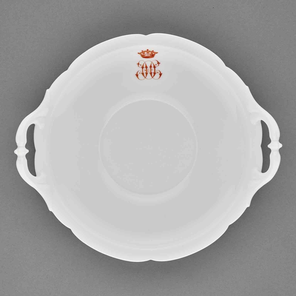 Plat rond à anse ; Service de porcelaine dure de Paris, Limoges et Bayeux au chiffre HO rouge commandé en 1878.