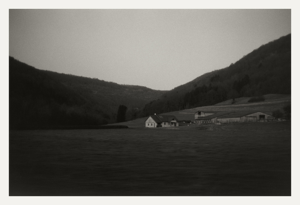 Aux environs d'Ornans, 2008. Prairie, bâtiments agricoles isolés et versants boisés