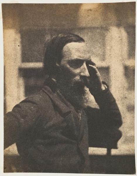 Autoportrait en buste, assis de trois-quarts, la main à la tempe